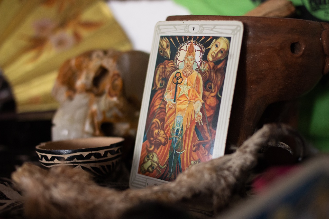 The Hierophant card from the Thoth tarot created by occultist Aleister Crowley and Lady Frieda Harris in 1943, surrounded by a crystal skull and taxidermy